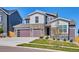 Charming two-story home with modern garage doors, stone accents, and a well-maintained lawn at 14337 Shasta Daisy Pt, Parker, CO 80134