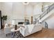 Elegant living room with a modern fireplace, high ceilings, and a staircase leading to the upper level at 14337 Shasta Daisy Pt, Parker, CO 80134