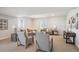 Spacious carpeted living room with ample seating, neutral color palette, and natural light from multiple windows at 14337 Shasta Daisy Pt, Parker, CO 80134