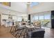 Bright and airy living room with a large sliding glass door, open to a modern kitchen at 14337 Shasta Daisy Pt, Parker, CO 80134