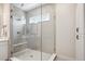 The glass enclosed walk-in shower features modern tile, a bench, and a window for natural light at 14337 Shasta Daisy Pt, Parker, CO 80134