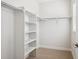 Clean walk-in closet featuring white walls and multiple storage shelves at 14337 Shasta Daisy Pt, Parker, CO 80134