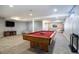 Finished basement recreation area with pool table, comfortable seating and entertainment center at 3080 E Geddes Pl, Centennial, CO 80122