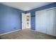 Spacious bedroom with light blue walls, carpeting, double door closet and an additional door at 3080 E Geddes Pl, Centennial, CO 80122