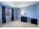 Bright bedroom with light blue walls, carpeting, and ample natural light from a window at 3080 E Geddes Pl, Centennial, CO 80122