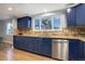 Modern kitchen with blue cabinets, granite countertops, and stainless steel appliances at 3080 E Geddes Pl, Centennial, CO 80122