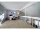 Home office loft area with window, carpeted flooring, and built-in desk and shelving at 3080 E Geddes Pl, Centennial, CO 80122