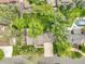 Bird's eye view of property features meticulously kept gardens, a pool, mature trees, and a manicured lawn at 11305 W 78Th Dr, Arvada, CO 80005