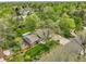 A home with mature trees, a well-maintained lawn, and a charming backyard is captured in an aerial shot at 11305 W 78Th Dr, Arvada, CO 80005