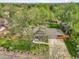 An aerial view showcases the home's beautiful landscaping, mature trees, and inviting curb appeal at 11305 W 78Th Dr, Arvada, CO 80005