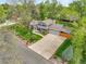 Beautiful aerial view of a landscaped property with mature trees and a long driveway at 11305 W 78Th Dr, Arvada, CO 80005