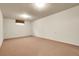 Spacious, carpeted basement with potential for customization, featuring a single window and neutral tones at 11305 W 78Th Dr, Arvada, CO 80005