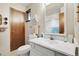 Bathroom featuring a single sink, vanity, and frosted sliding glass door shower at 11305 W 78Th Dr, Arvada, CO 80005