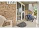 Close-up of the front entrance with a welcome mat and seating at 11305 W 78Th Dr, Arvada, CO 80005