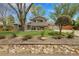 Charming two-story home featuring mature landscaping and a well-manicured front yard at 11305 W 78Th Dr, Arvada, CO 80005