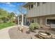 Inviting front porch area with outdoor seating and a well-kept garden at 11305 W 78Th Dr, Arvada, CO 80005