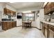 Bright eat-in kitchen featuring wood cabinets, large window and tile flooring at 11305 W 78Th Dr, Arvada, CO 80005