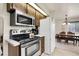 Kitchen features stainless steel appliances, wood cabinets and is near the dining room at 11305 W 78Th Dr, Arvada, CO 80005