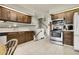 Bright kitchen with wood cabinets, stainless steel appliances and access to the stairwell at 11305 W 78Th Dr, Arvada, CO 80005
