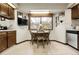 Eat-in kitchen area shows wood cabinets, stainless steel appliances and a window view at 11305 W 78Th Dr, Arvada, CO 80005