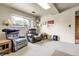 Relaxing living area with recliner chairs, side tables, and a window for natural light and comfort at 11305 W 78Th Dr, Arvada, CO 80005