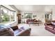 Spacious living room with large windows, plush seating, and classic decor at 11305 W 78Th Dr, Arvada, CO 80005