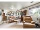 Cozy living room with plush seating, natural light, and built-in shelving, perfect for relaxation at 11305 W 78Th Dr, Arvada, CO 80005