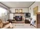 Living room with wood burning stove, brick fireplace, and a mounted flatscreen television at 11305 W 78Th Dr, Arvada, CO 80005
