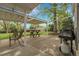 Relaxing outdoor patio featuring a picnic table, seating, and a grill for barbecuing in a yard at 11305 W 78Th Dr, Arvada, CO 80005