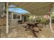 Outdoor patio featuring a picnic table, seating, and string lights, great for entertaining guests at 11305 W 78Th Dr, Arvada, CO 80005