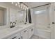 Bathroom featuring a double sink vanity, modern fixtures, and shower-tub combo at 2171 E 99Th Pl, Thornton, CO 80229