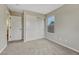 Bedroom featuring new carpet, neutral paint, closet with sliding doors, and access to another room at 2171 E 99Th Pl, Thornton, CO 80229