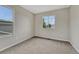 Bedroom featuring new carpet, neutral paint, and a large window with backyard views at 2171 E 99Th Pl, Thornton, CO 80229