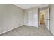 Bedroom featuring neutral paint, new carpet, and closet with sliding doors at 2171 E 99Th Pl, Thornton, CO 80229