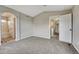 Bedroom featuring neutral paint, new carpet, and ensuite bathroom at 2171 E 99Th Pl, Thornton, CO 80229