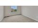 Bright, neutrally decorated bedroom with new carpet and a large window overlooking the yard at 2171 E 99Th Pl, Thornton, CO 80229