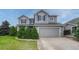 Charming two-story home featuring a gray exterior with blue shutters and a well-manicured front yard at 2171 E 99Th Pl, Thornton, CO 80229
