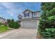 Attractive gray two-story home with blue shutters, showcasing a tidy front yard and attached garage at 2171 E 99Th Pl, Thornton, CO 80229