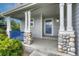 Welcoming front porch featuring stone-covered posts and a blue railing, adding character to the home's entrance at 2171 E 99Th Pl, Thornton, CO 80229