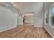 Bright open-concept area with high ceilings, wood-look floors, and seamless flow to kitchen at 2171 E 99Th Pl, Thornton, CO 80229