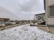 Rear view of the house with a fenced yard, patio, grill, and view of neighborhood traffic at 17265 E 110Th Ct, Commerce City, CO 80022
