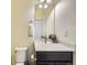 Cozy powder room features a single sink vanity and neutral paint at 17265 E 110Th Ct, Commerce City, CO 80022