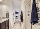 Modern bathroom with a glass-enclosed shower, neutral tile, and access to the bedroom at 17265 E 110Th Ct, Commerce City, CO 80022