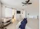 Bright bedroom includes a ceiling fan, crib, and access to an ensuite bathroom and closet at 17265 E 110Th Ct, Commerce City, CO 80022