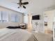 Neutral bedroom with a ceiling fan, crib, and closet access at 17265 E 110Th Ct, Commerce City, CO 80022