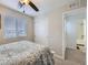 Bedroom showcasing a comfortable bed, window with blinds, closet, and en-suite bathroom at 17265 E 110Th Ct, Commerce City, CO 80022