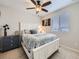 Bright bedroom with a large window, ceiling fan, white trim, and comfortable furnishings at 17265 E 110Th Ct, Commerce City, CO 80022