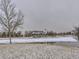 Community clubhouse with a lake view, featuring an American flag at 17265 E 110Th Ct, Commerce City, CO 80022