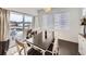 Bright dining room featuring a stylish chandelier, modern decor, and view of backyard at 17265 E 110Th Ct, Commerce City, CO 80022