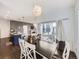 Bright dining room featuring a stylish chandelier, modern decor, and hardwood floors at 17265 E 110Th Ct, Commerce City, CO 80022